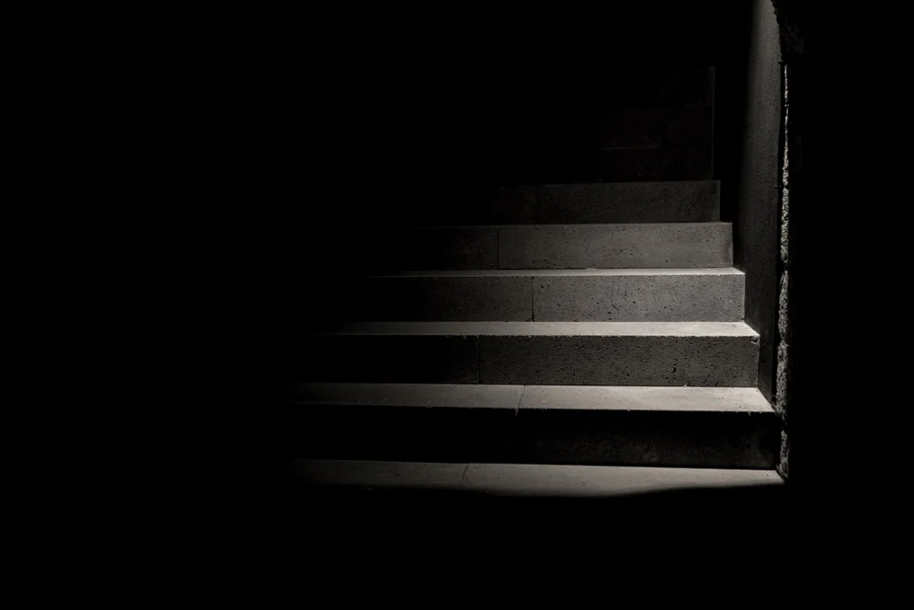 Light shining on dark stairwell