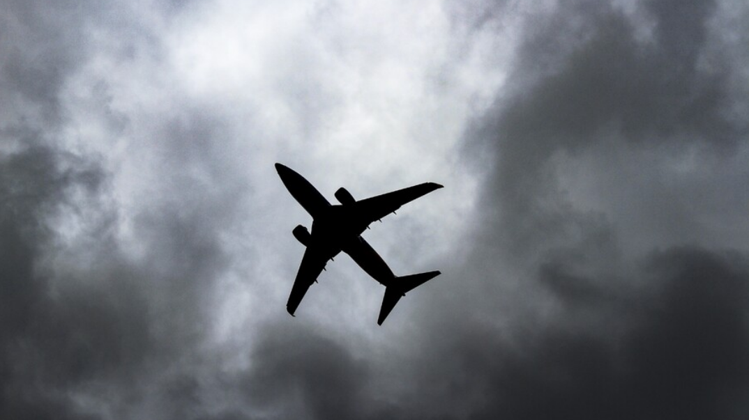 Airplane in a dark cloudy sky
